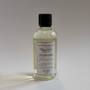 Bottle of 'New Beginnings' fragrance with a black cap on a light gray background